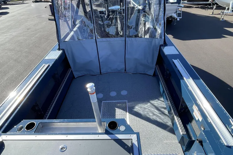 Slide: The Image of 2026 Hewescraft 210 Sea Runner ET boat interior with protective cover and spacious deck. - 7