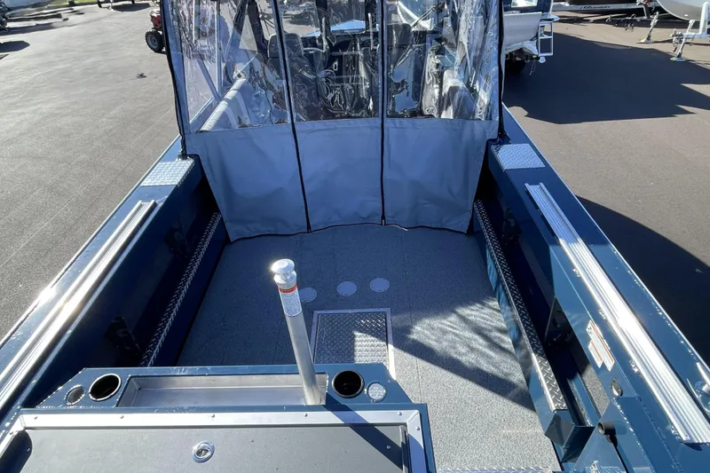 Slide: The Image of 2026 Hewescraft 210 Sea Runner ET boat interior with protective cover and spacious deck. - 8