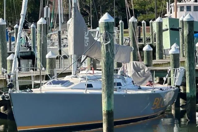 Slide: The Image of 2002 J Boats J/105 sailboat docked at marina with covered sails. - 2