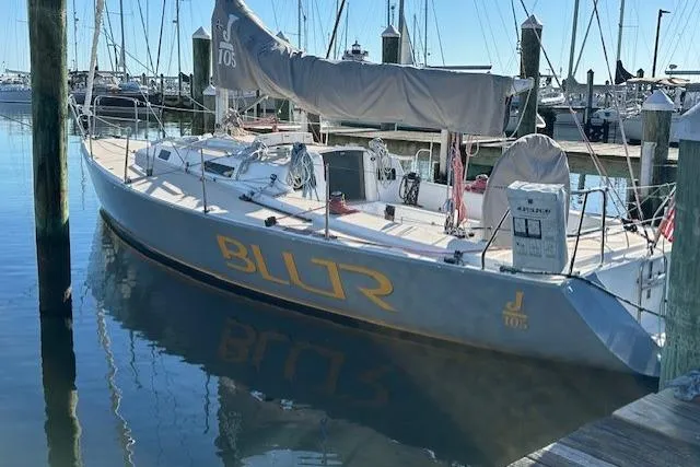 Slide: The Image of 2002 J Boats J/105 sailboat docked in marina, named "BLUR". - 3