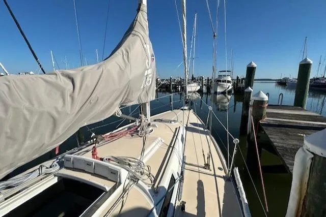 Slide: The Image of 2002 J Boats J/105 sailboat docked at marina, clear blue sky. - 5