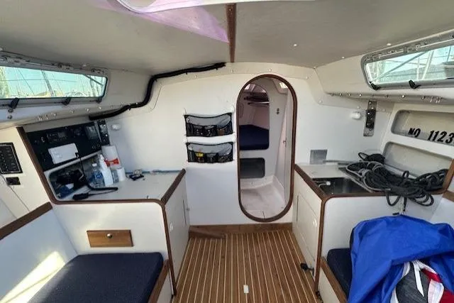 Slide: The Image of Interior of 2002 J Boats J/105 sailboat with wood flooring and compact cabin layout. - 6