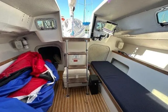 Slide: The Image of Interior of 2002 J Boats J/105 sailboat with wooden flooring and compact cabin layout. - 7