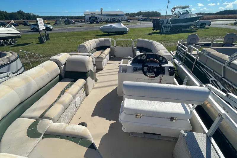 Slide: The Image of 2005 Avalon Paradise RF22 pontoon boat interior with seating and steering console. - 9