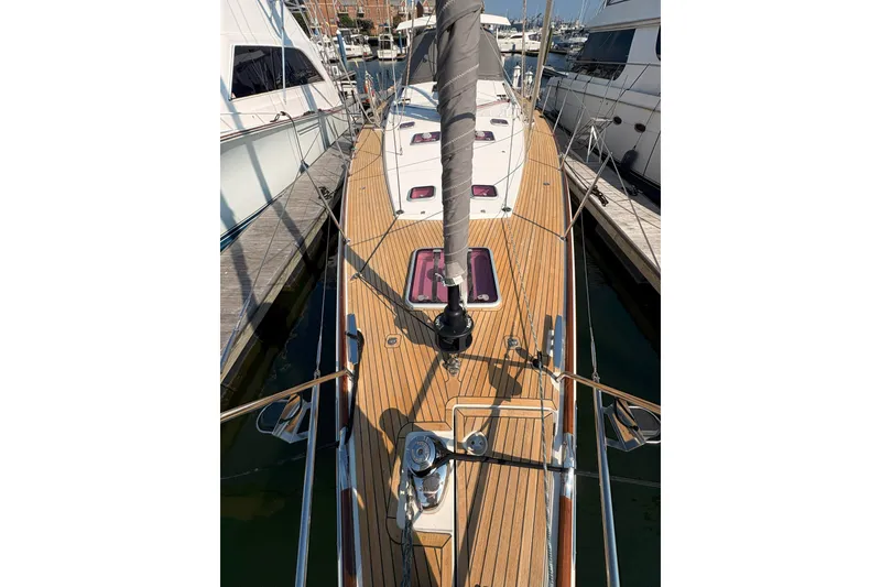 Slide: The Image of 2012 Jeanneau 57 sailboat with teak deck, docked at marina. - 12