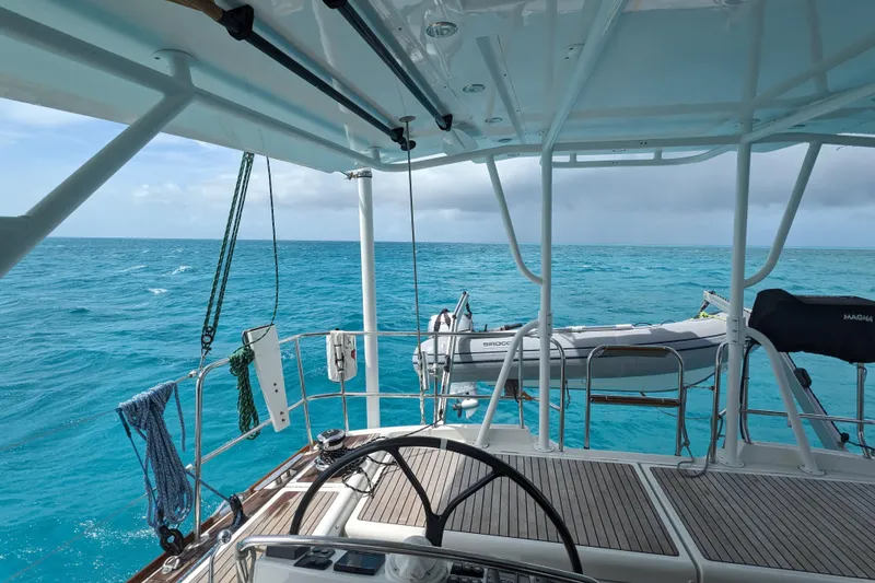 Slide: The Image of Cockpit view from a 2012 Jeanneau 57 yacht overlooking turquoise ocean waters. - 34