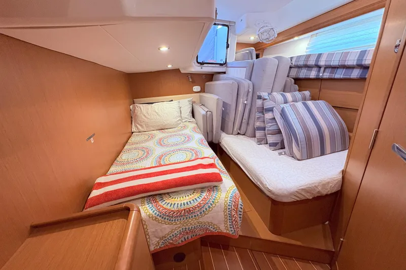 Slide: The Image of Cozy cabin interior of 2012 Jeanneau 57 yacht with colorful bedding and cushions. - 52