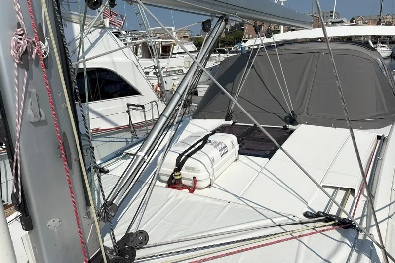 Slide: The Image of 2012 Jeanneau 57 sailboat deck with rigging and covered cockpit in marina. - 6