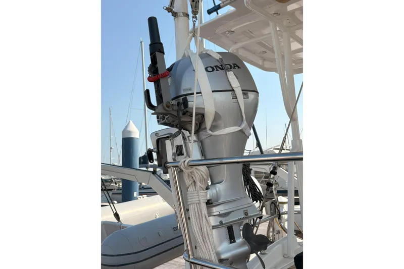 Slide: The Image of Outboard motor on a 2012 Jeanneau 57 sailboat, docked at a marina. - 8