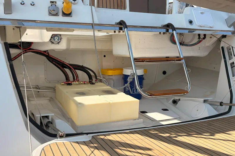 Slide: The Image of 2012 Jeanneau 57 yacht stern with storage compartment and ladder. - 9