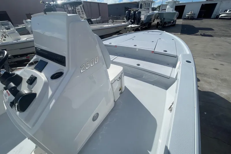 Slide: The Image of 2026 Pathfinder 2500 Hybrid boat, sleek design, docked with other vessels in a marina. - 11