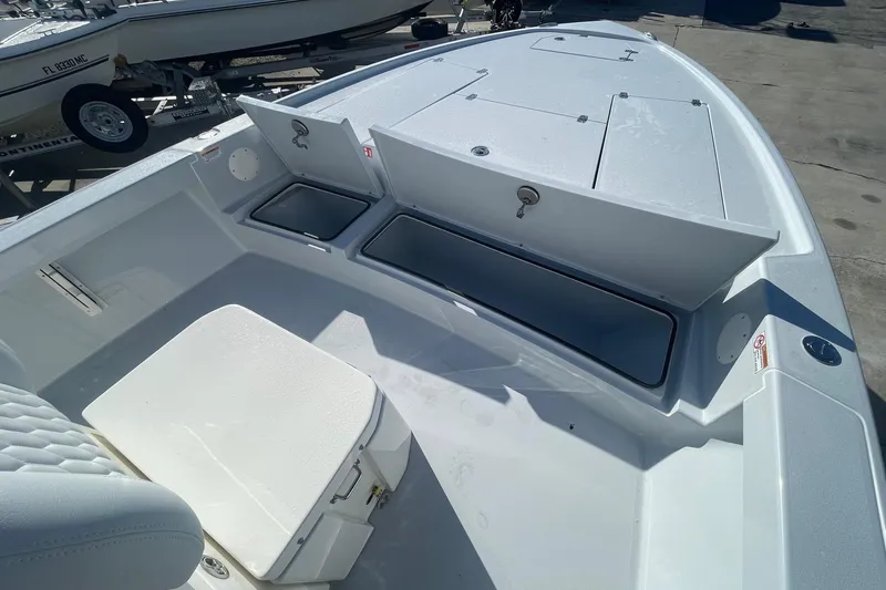 Slide: The Image of 2026 Pathfinder 2500 Hybrid boat interior with open storage compartments and seating. - 13
