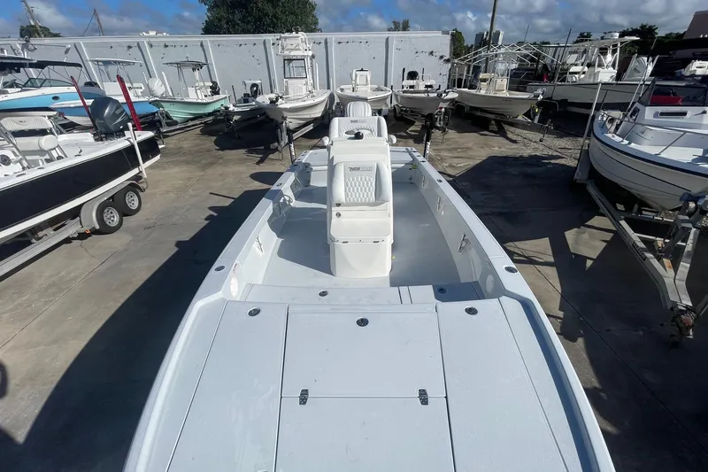 Slide: The Image of 2026 Pathfinder 2500 Hybrid boat in a marina, surrounded by other vessels. - 14