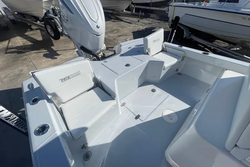 Slide: The Image of 2026 Pathfinder 2500 Hybrid boat interior with seating and motor, docked outdoors. - 15