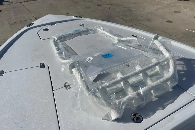 Slide: The Image of 2026 Pathfinder 2500 Hybrid boat deck with packaged accessories in sunlight. - 18