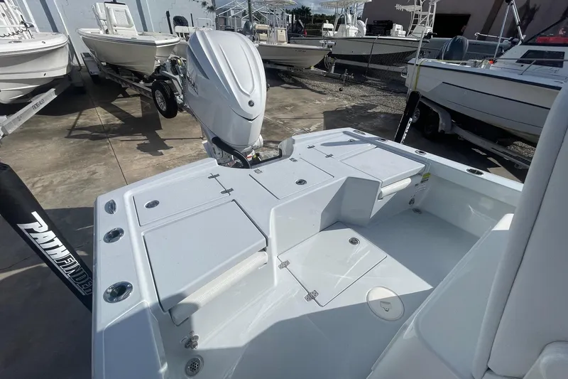 Slide: The Image of 2026 Pathfinder 2500 Hybrid boat with outboard motor, displayed in a marina setting. - 6