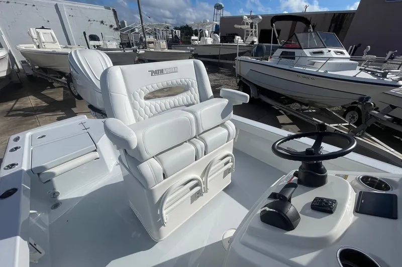 Slide: The Image of 2026 Pathfinder 2500 Hybrid boat interior with white seating and steering console. - 7