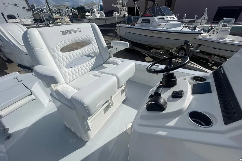 Slide: The Image of 2026 Pathfinder 2500 Hybrid boat interior with white seating and steering console. - 8