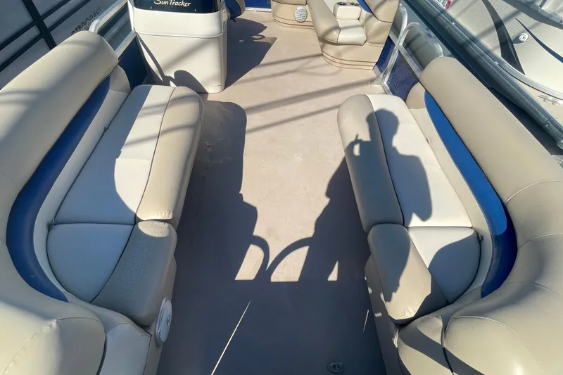 Slide: The Image of 2013 Sun Tracker Party Barge 18 DLX interior with beige seating and blue accents. - 9
