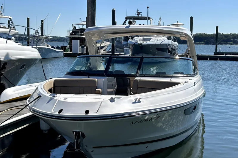 Slide: The Image of 2016 Sea Ray 350 SLX boat docked at marina on a sunny day. - 1