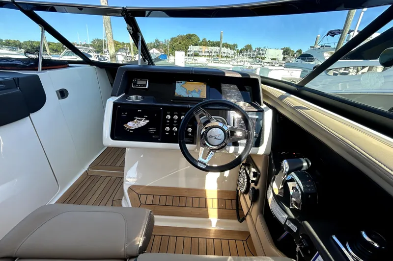 Slide: The Image of 2016 Sea Ray 350 SLX boat cockpit with modern controls and navigation system. - 3