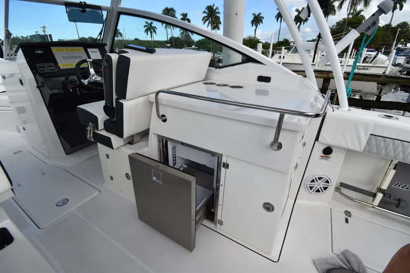 Slide: The Image of 2022 Blackfin 272DC boat interior with helm, seating, and storage compartments. - 12