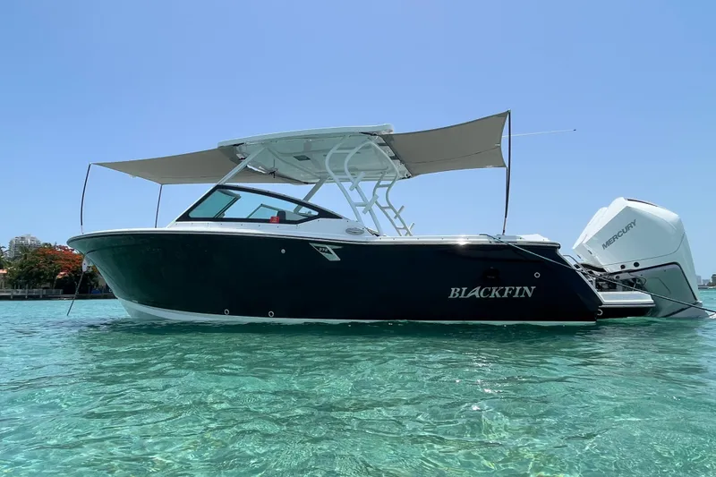 Slide: The Image of 2022 Blackfin 272DC boat on clear turquoise water under a sunny sky. - 2