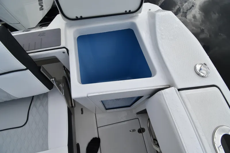 Slide: The Image of 2022 Blackfin 272DC boat interior with open storage compartment and seating. - 29