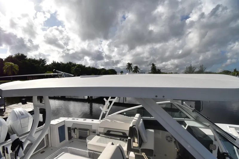 Slide: The Image of 2022 Blackfin 272DC boat with seating, under a cloudy sky by the water. - 33