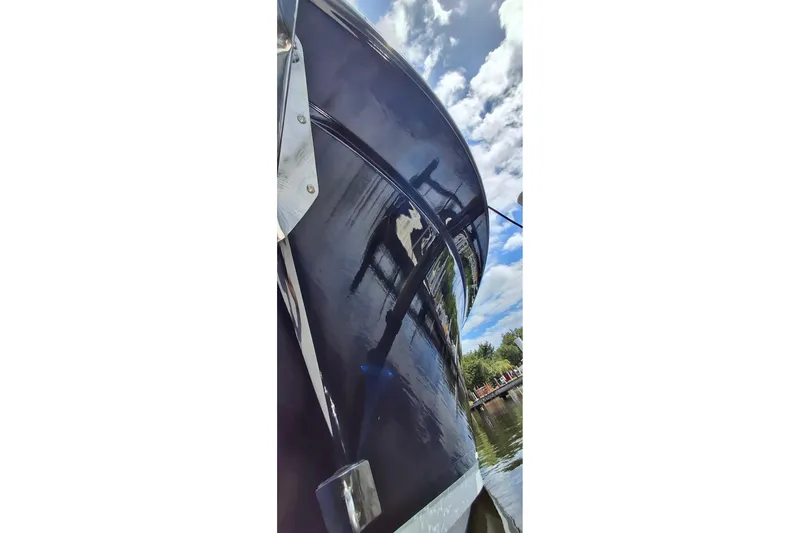 Slide: The Image of 2023 Blackfin 272DC boat hull reflecting sky and water at a marina. - 34