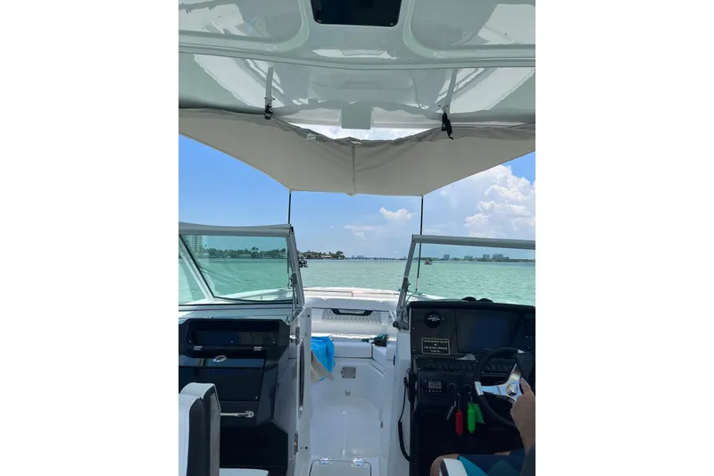 Slide: The Image of Interior view of 2022 Blackfin 272DC boat, showcasing helm and open water ahead. - 5