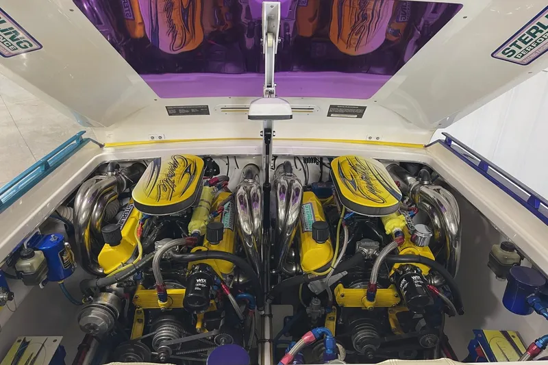 Slide: The Image of 2002 Cigarette 38 Top Gun engine compartment with vibrant yellow and chrome details. - 11