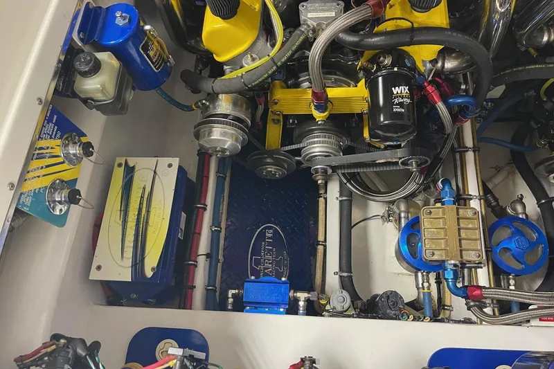 Slide: The Image of Engine compartment of a 2002 Cigarette 38 Top Gun boat, showcasing detailed components. - 12