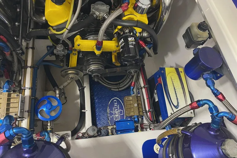 Slide: The Image of Engine compartment of a 2002 Cigarette 38 Top Gun boat, featuring vibrant components. - 13