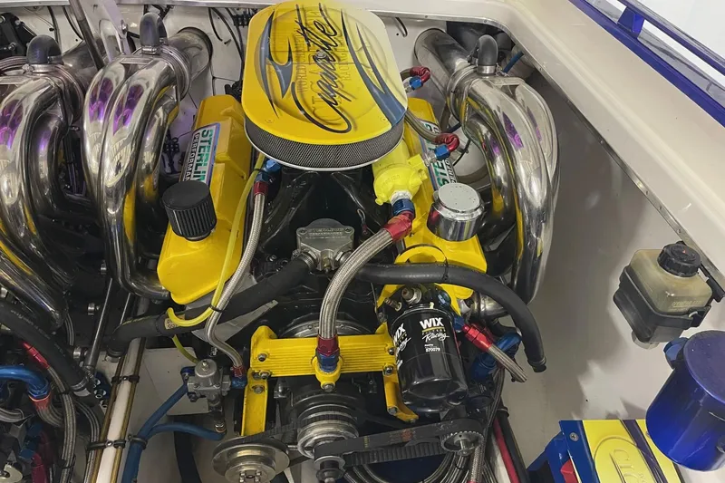 Slide: The Image of Engine of a 2002 Cigarette 38 Top Gun boat with vibrant yellow accents. - 15