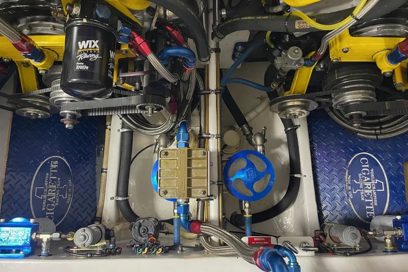 Slide: The Image of Engine compartment of a 2002 Cigarette 38 Top Gun boat with detailed components. - 16