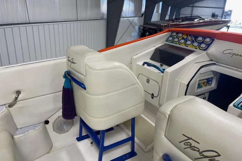 Slide: The Image of Interior of a 2002 Cigarette 38 Top Gun boat with white seating and control panel. - 17