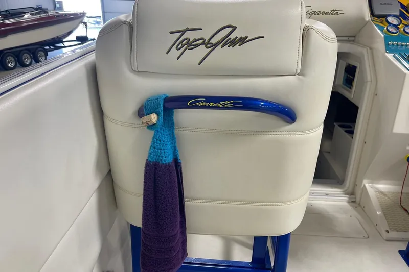 Slide: The Image of 2002 Cigarette 38 Top Gun boat seat with embroidered logo and towel hanging. - 20