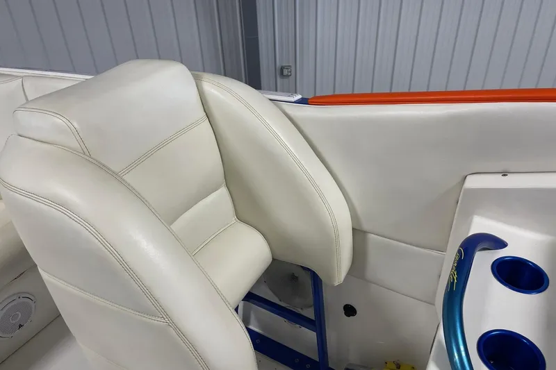 Slide: The Image of 2002 Cigarette 38 Top Gun boat interior with white leather seating and blue cup holders. - 23
