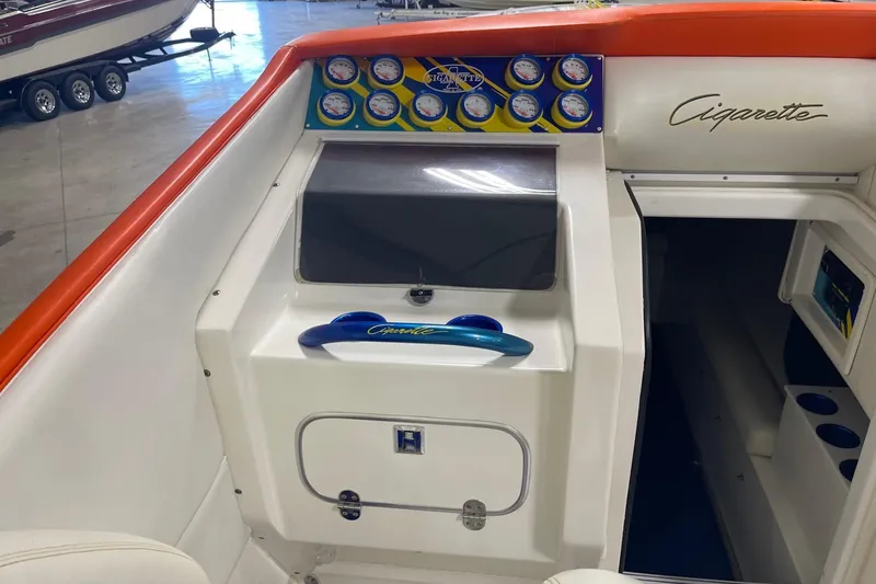 Slide: The Image of 2002 Cigarette 38 Top Gun boat dashboard with gauges and signature logo. - 24