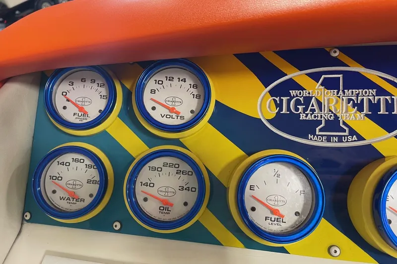 Slide: The Image of Dashboard gauges of a 2002 Cigarette 38 Top Gun boat, featuring fuel, volts, water, and oil indicators. - 25