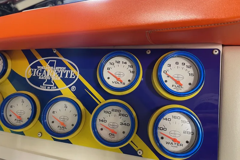 Slide: The Image of Dashboard gauges of a 2002 Cigarette 38 Top Gun boat, featuring fuel, volts, and temperature indicators. - 26