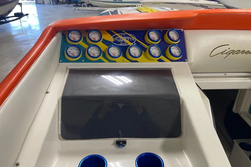 Slide: The Image of 2002 Cigarette 38 Top Gun dashboard with colorful gauges and logo. - 27