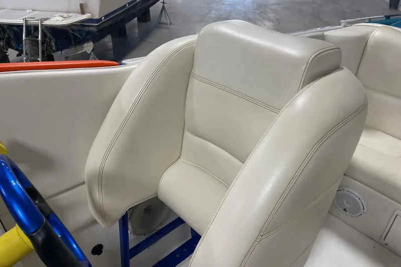 Slide: The Image of 2002 Cigarette 38 Top Gun boat interior with white leather seat and blue steering wheel. - 29