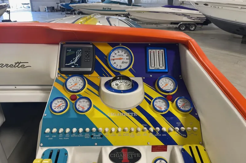 Slide: The Image of Dashboard of a 2002 Cigarette 38 Top Gun boat with colorful gauges and controls. - 31