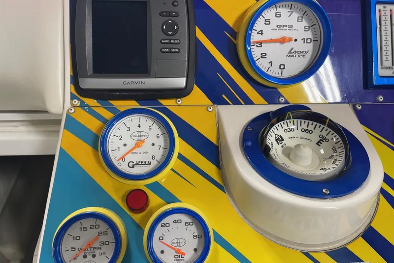 Slide: The Image of Dashboard of a 2002 Cigarette 38 Top Gun boat with gauges and Garmin GPS. - 32