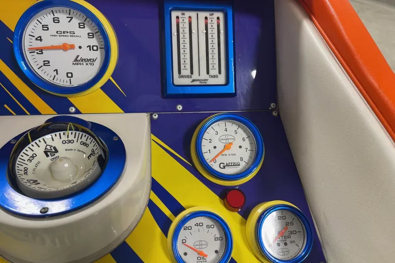 Slide: The Image of Dashboard of a 2002 Cigarette 38 Top Gun boat with colorful gauges and controls. - 33