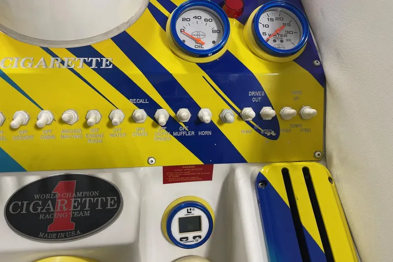 Slide: The Image of Control panel of a 2002 Cigarette 38 Top Gun boat with gauges and switches. - 35