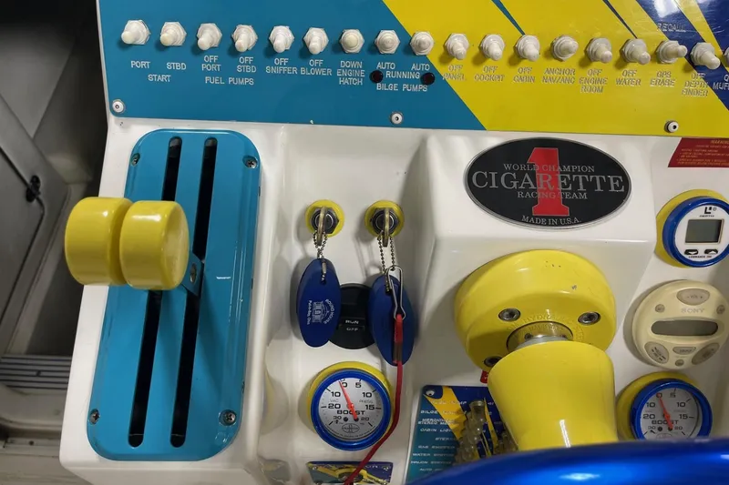 Slide: The Image of Control panel of a 2002 Cigarette 38 Top Gun boat with switches and gauges. - 37