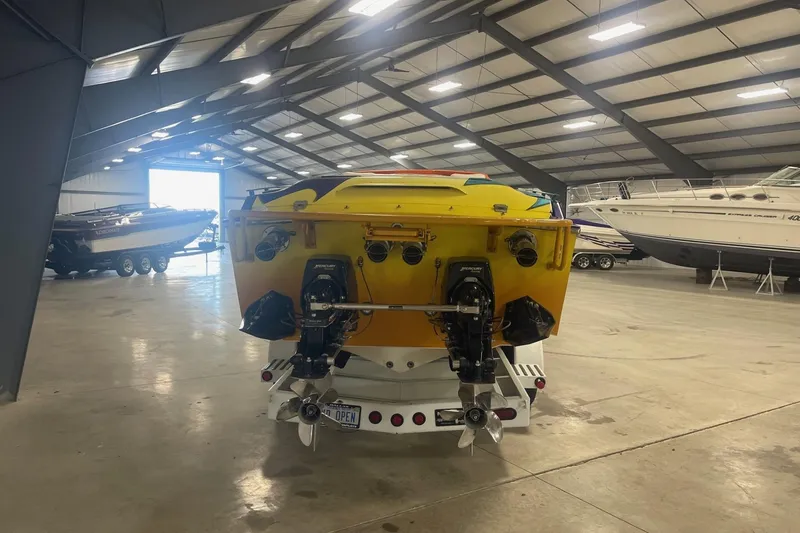 Slide: The Image of 2002 Cigarette 38 Top Gun boat in a spacious indoor storage facility. - 4